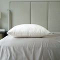 a down alternative pillow on a bed