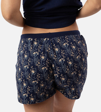back view of models legs wearing midnight floral print sleep shorts