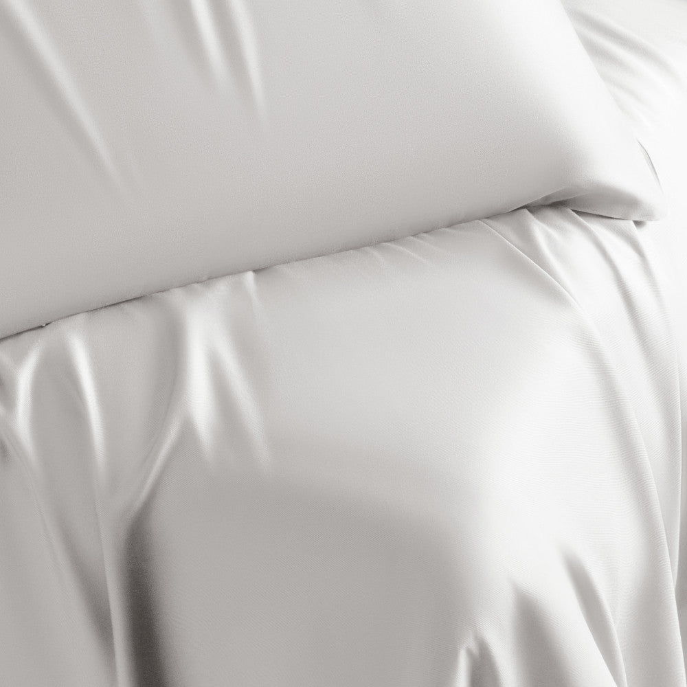 close-up on bed made with white retreat sheets