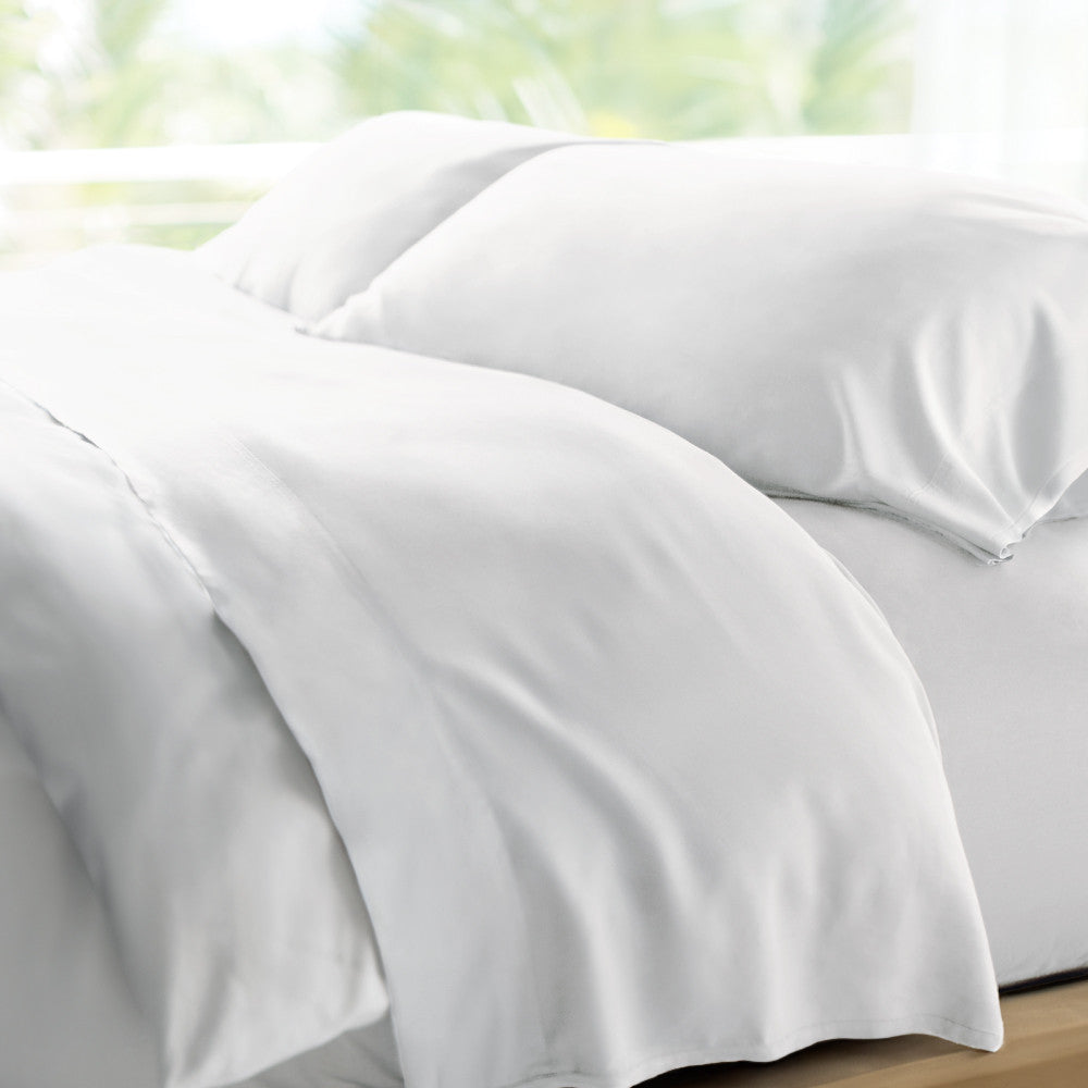 bed made with white retreat sheets~White