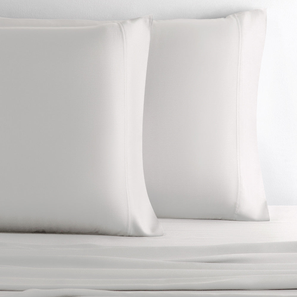 two pillows with white pillowcases~White