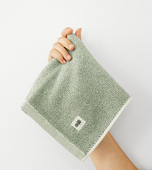 models hand holding up a washcloth