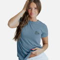 front view of model wearing coastal blue crew tee with our sandbar surf shack left chest design