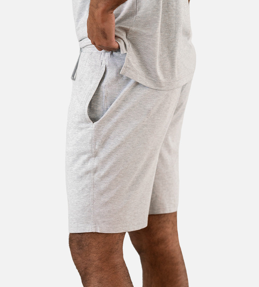 close-up side view of model wearing light gray shorts