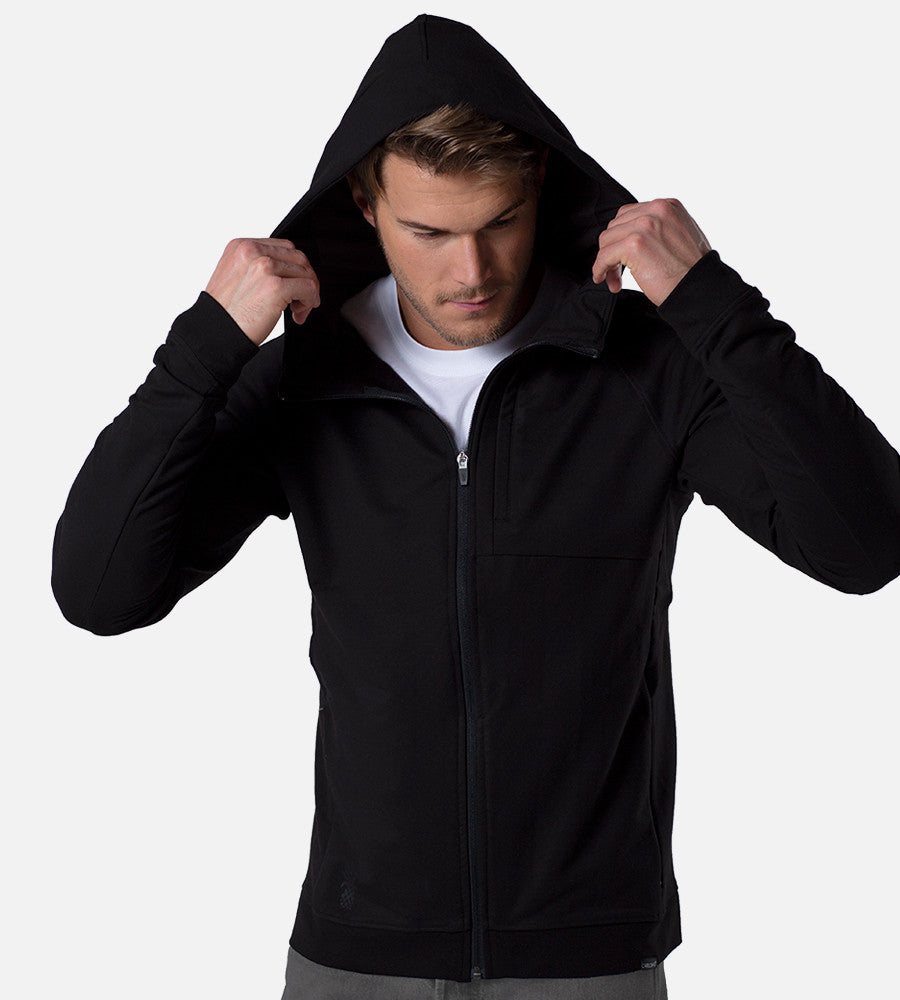 front view of model wearing black zip hoodie with the hood up