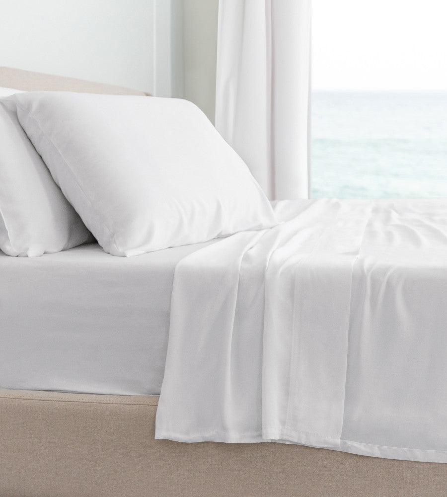 side of bed showcasing classic white sheets