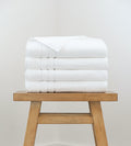 4 bath towels on a stool