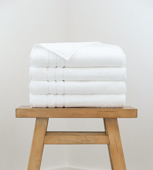 4 bath towels on a stool