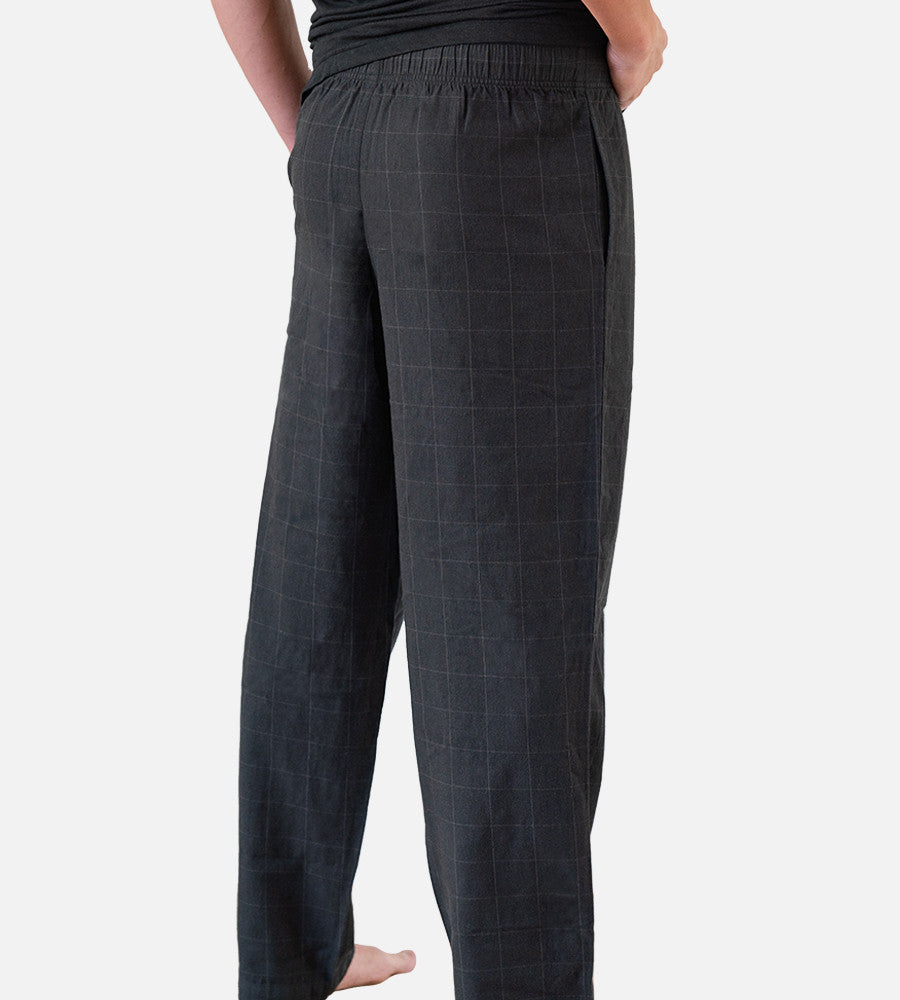 close-up back view of model wearing woven black pants~Plaid Black