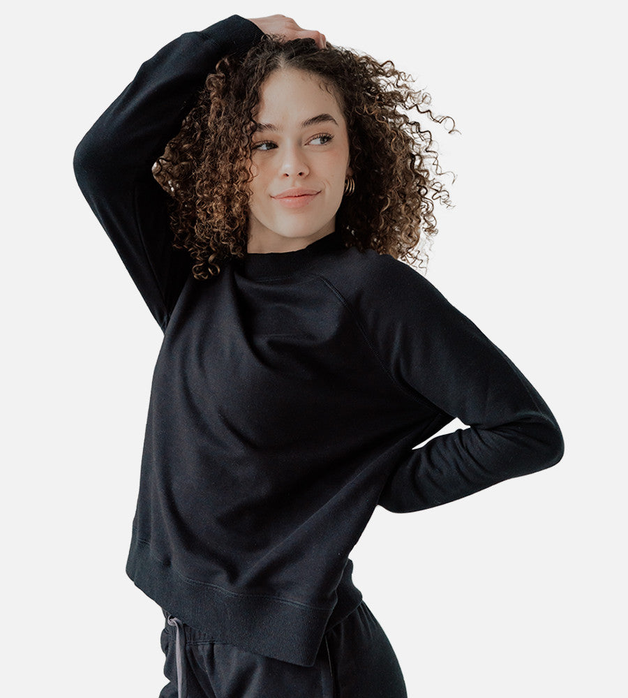 front view of model wearing black pullover sweatshirt~Black