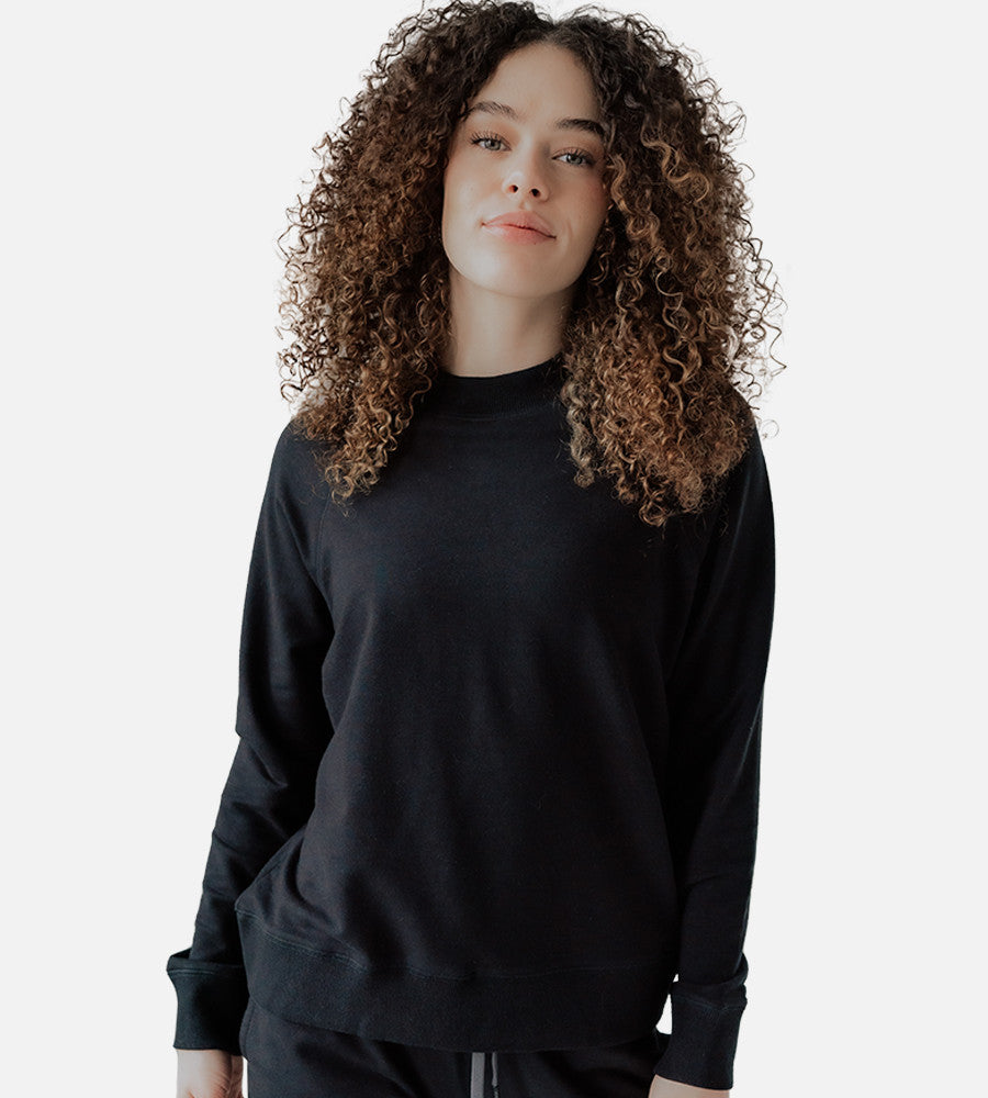 front view of model wearing black pullover sweatshirt~Black