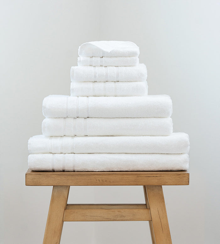2 bath sheets, 2 bath towels, 2 hand towels and 2 washcloths on a stool