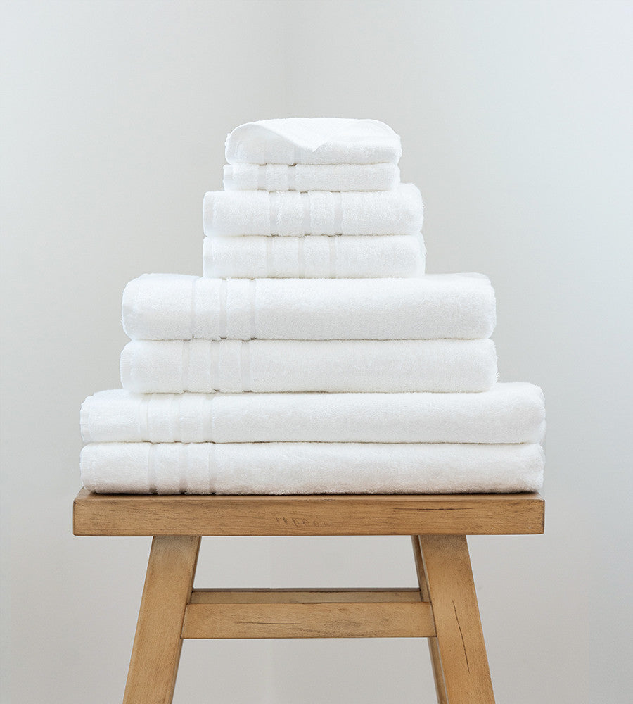 2 bath sheets, 2 bath towels, 2 hand towels and 2 washcloths on a stool~White