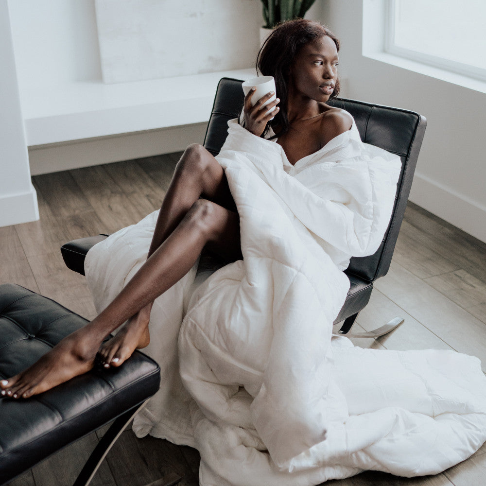 model wrapped in comforter