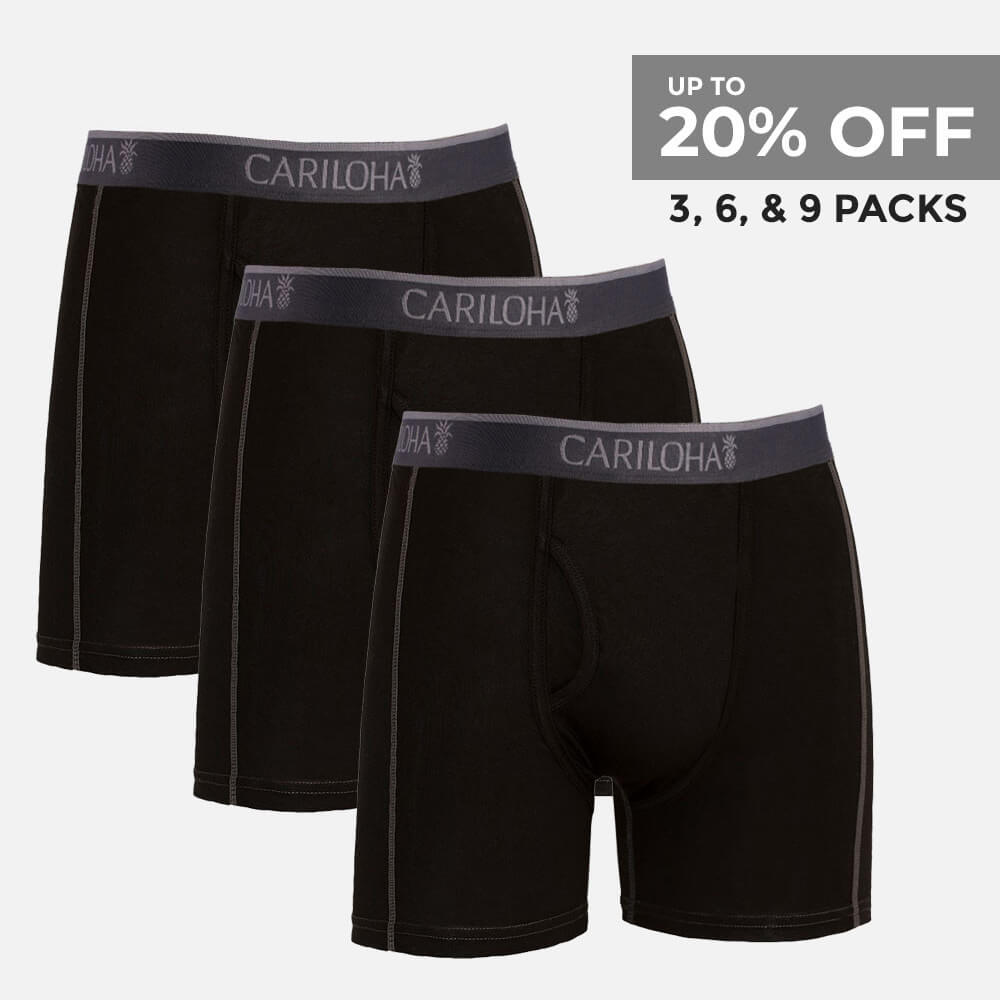 Three pairs of black men's boxer briefs with dark gray elastic waistbands featuring the brand name 'CARILOHA' in white, arranged in a staggered stack on a light gray background. A promotional text overlay in the top right corner reads 'UP TO 20% OFF 3, 6, & 9 PACKS'.