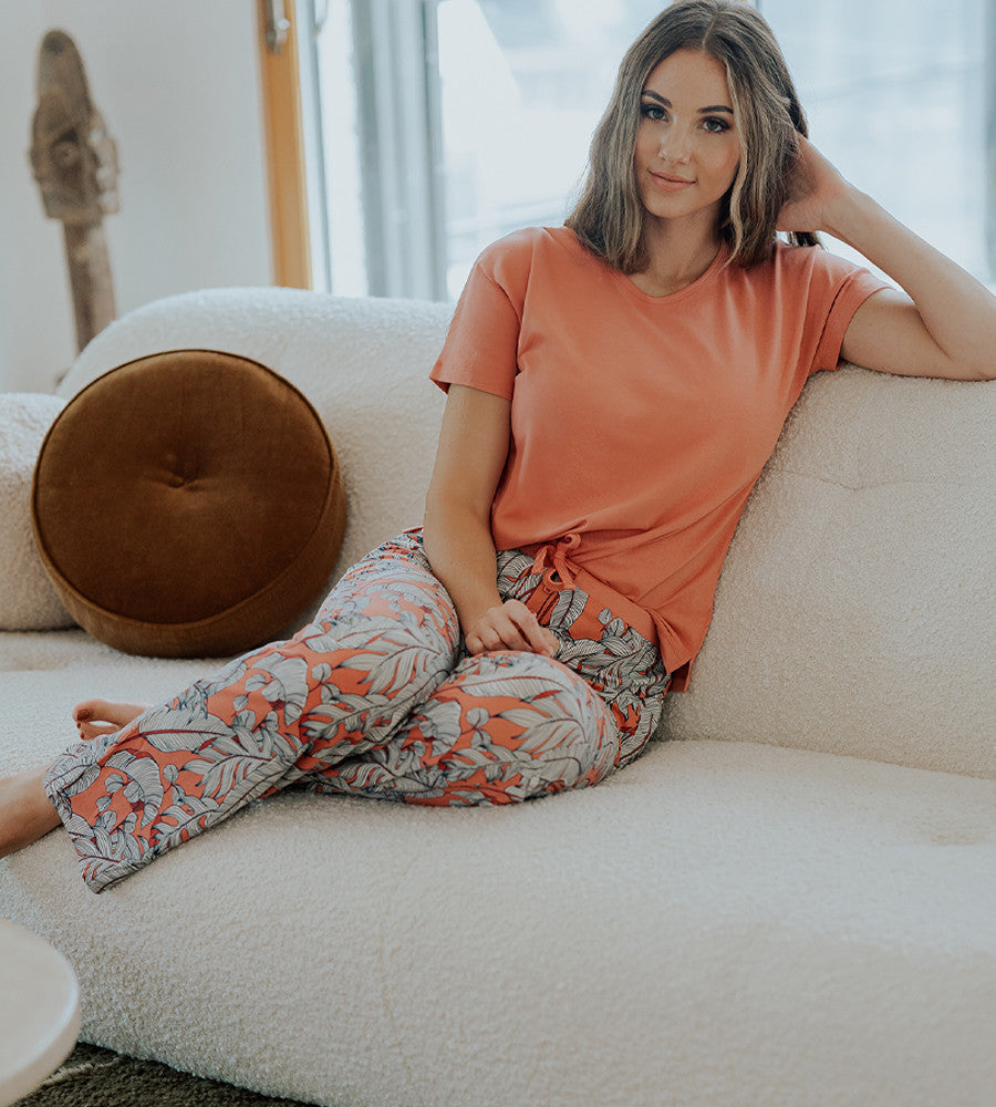model wearing blush foliage print pants