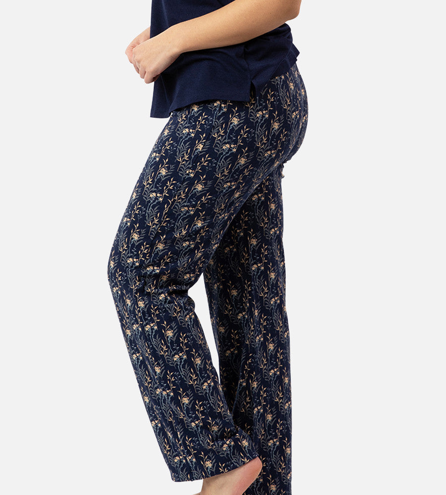 side view of models legs wearing midnight floral print pants