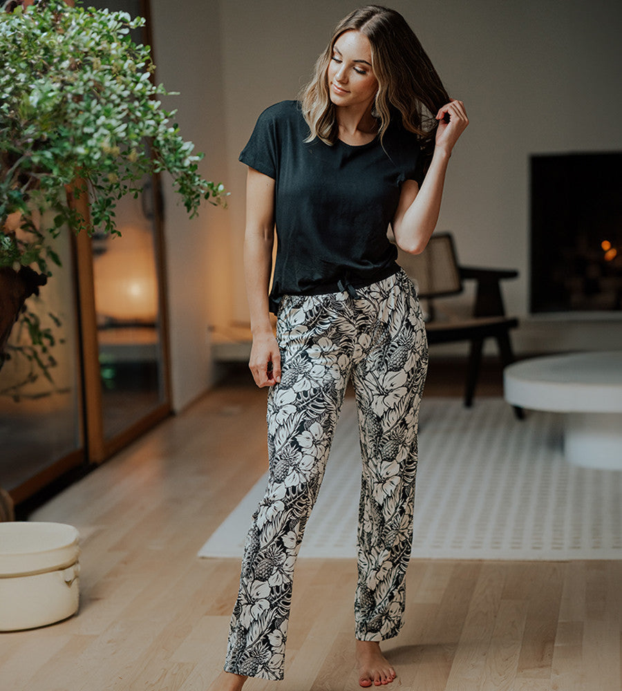 model wearing soft black pineapple print pants