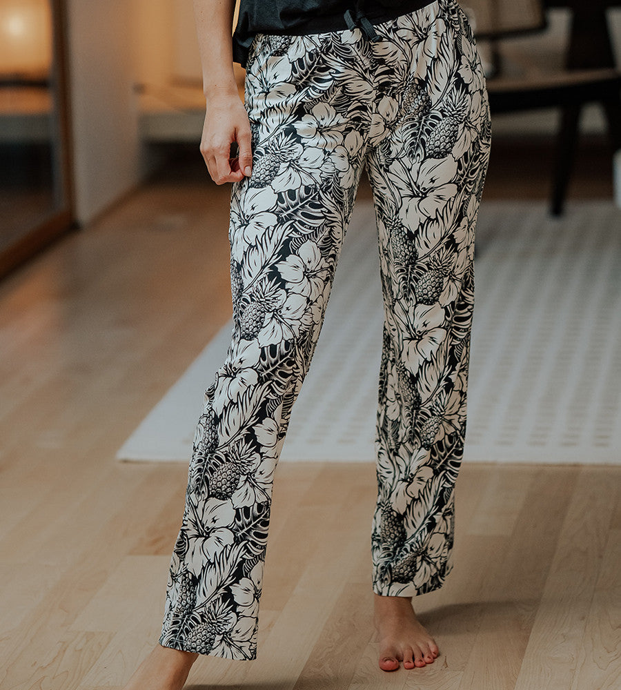 view of models legs wearing soft black pineapple print pants