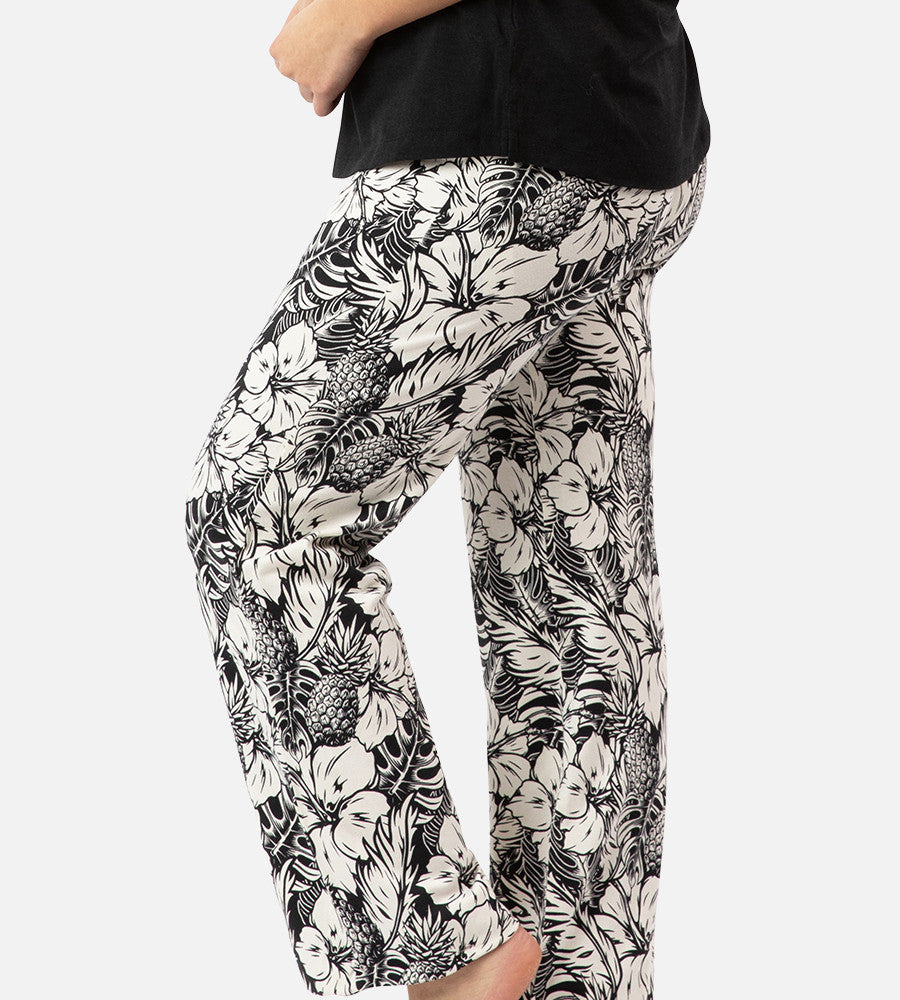 side view of models legs wearing soft black pineapple print pants