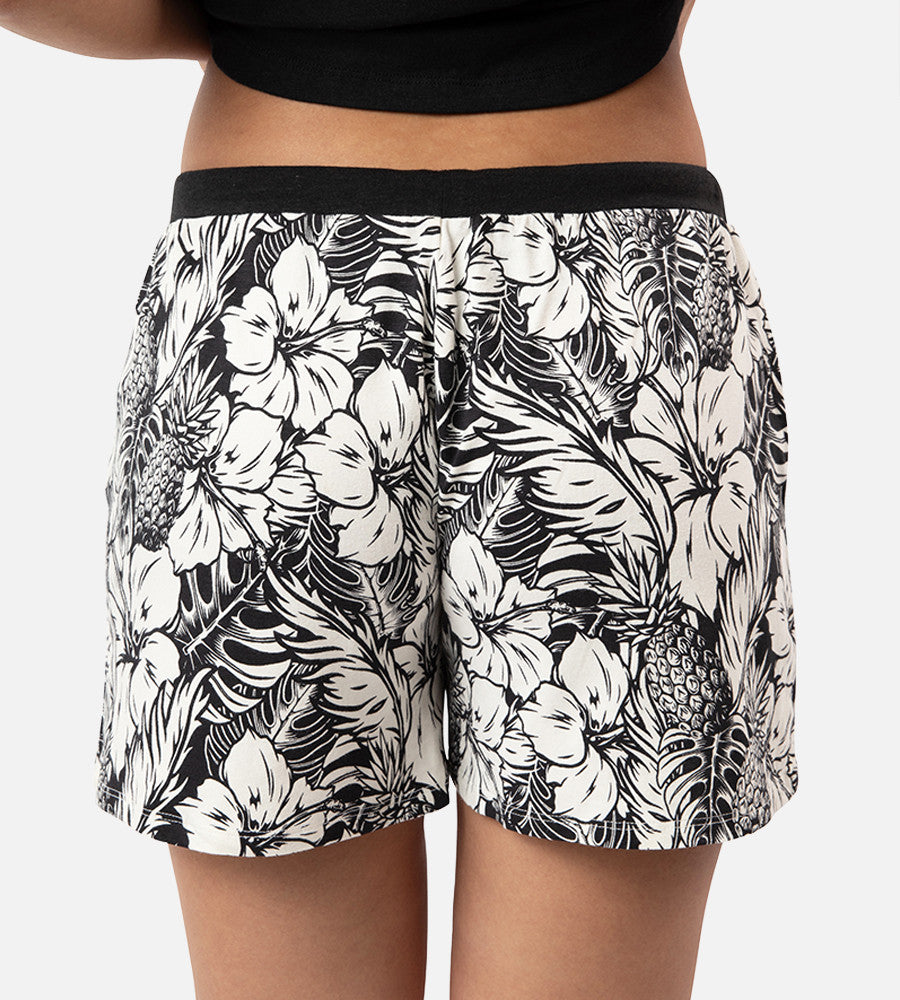 back view of models legs wearing soft black pineapple print sleep shorts
