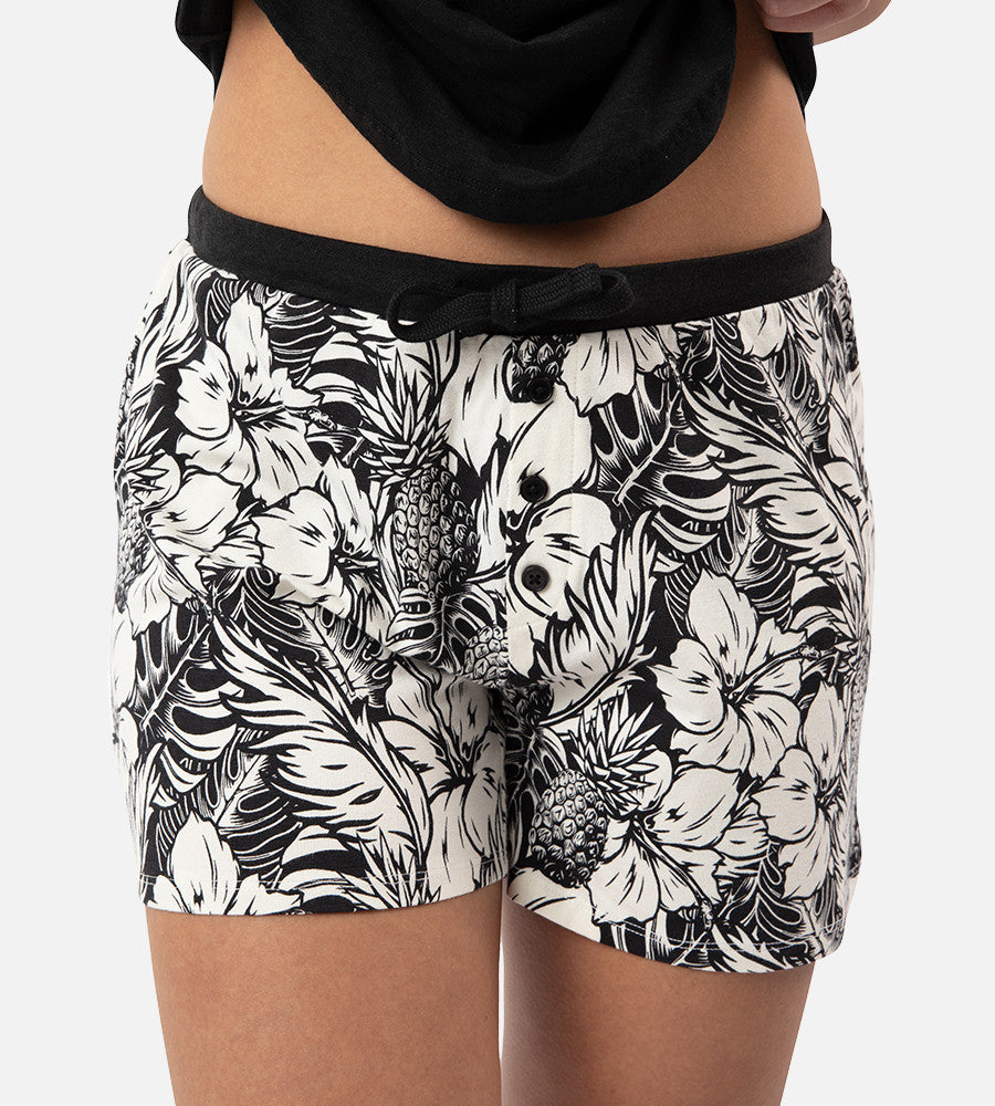 front view of models legs wearing soft black pineapple print sleep shorts