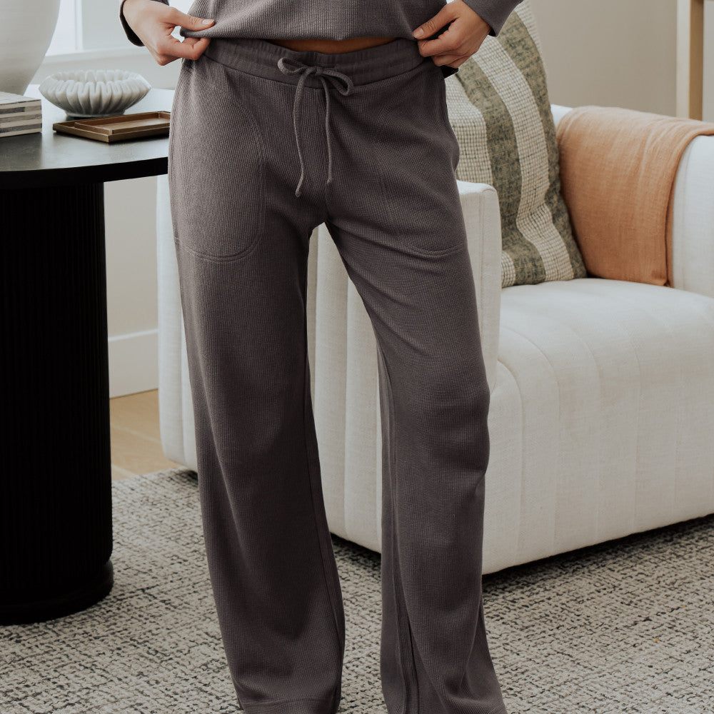 front view of model wearing charcoal pants