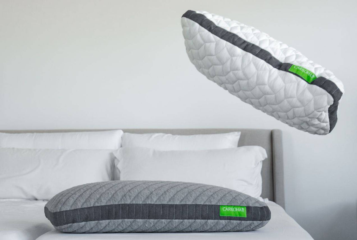 A Cariloha pillow being tossed onto a bed