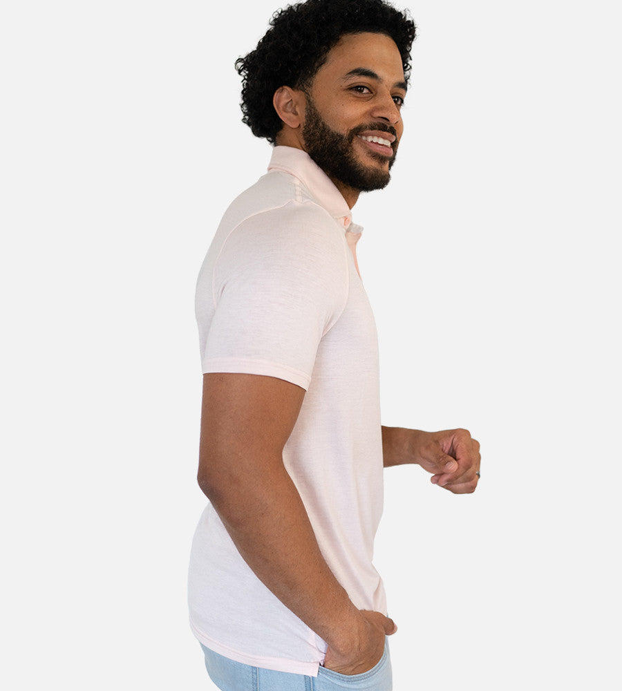 side view of model wearing light pink comfort polo~Light Pink