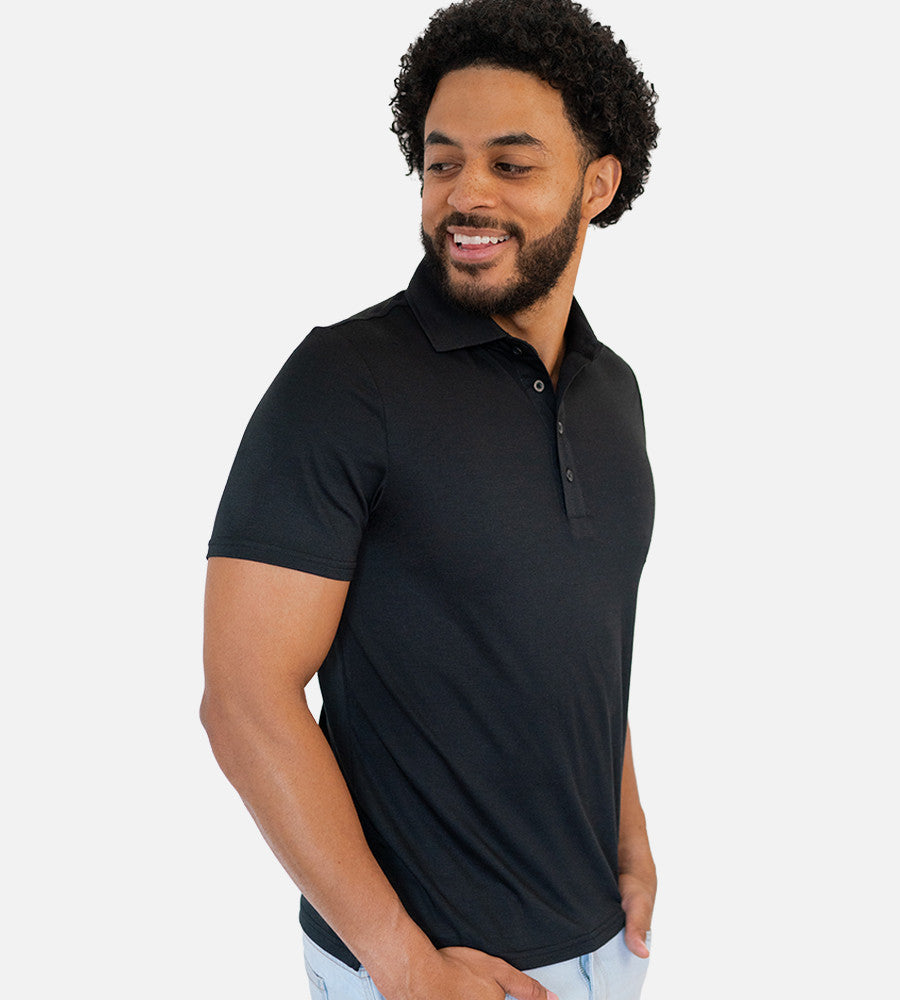 side view of model wearing back comfort polo~Black