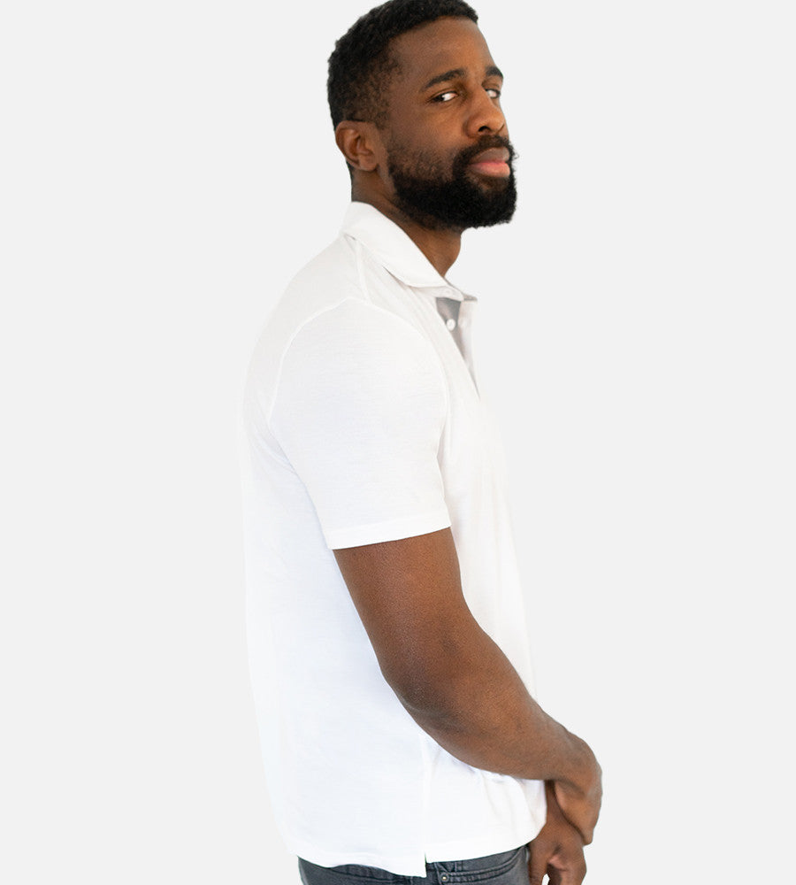 side view of model wearing white polo~White