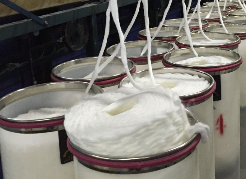 bamboo yarn being spun into large barrels 