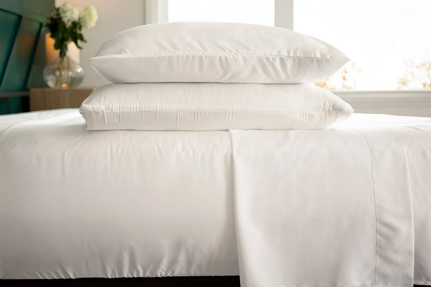 White bamboo sheets and pillows on a bed